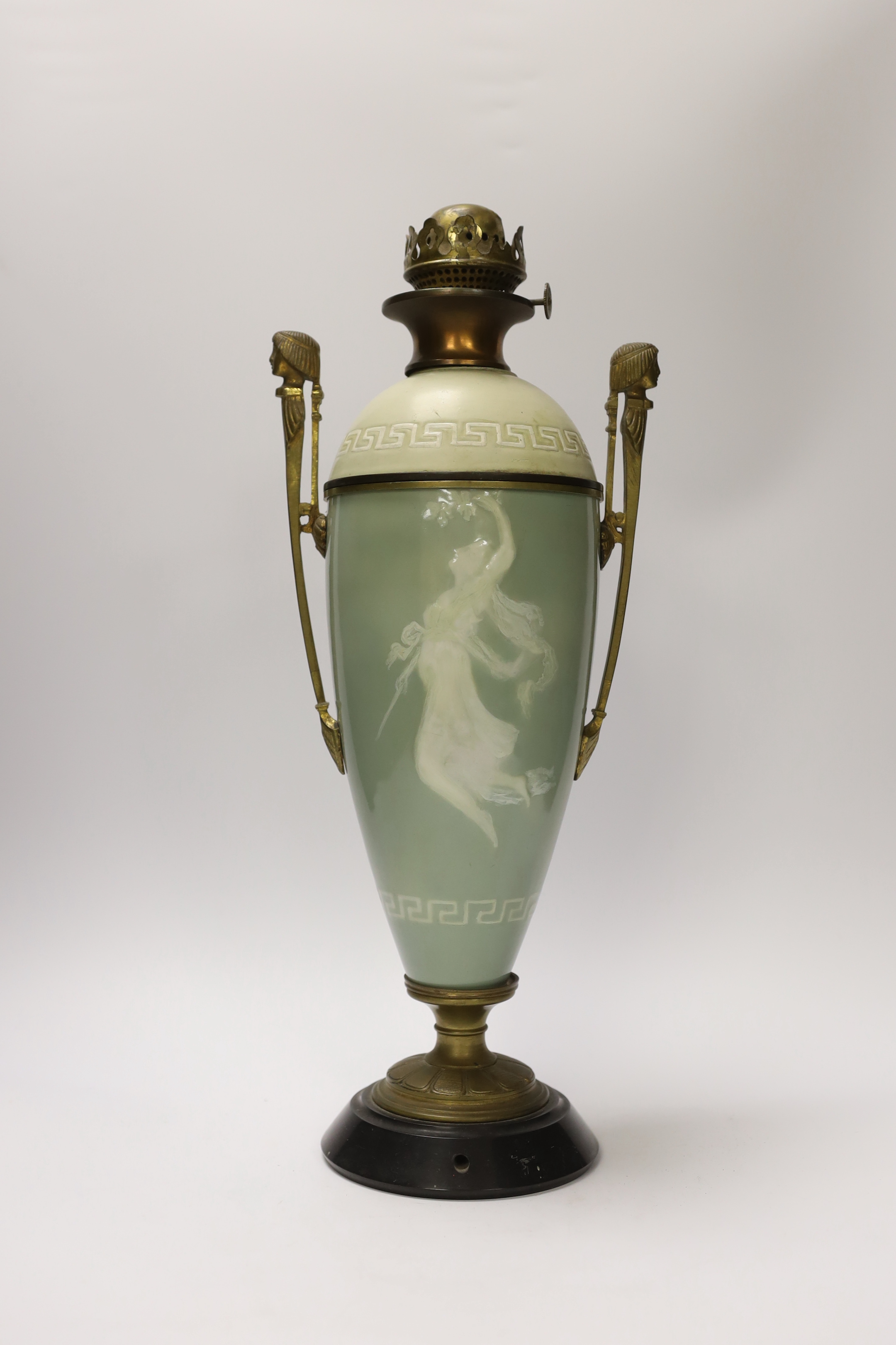 A late 19th century pate sur pate and gilt metal oil lamp with twin handles (restoration), 44cm